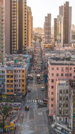 Busy roadway fills with taxis and pedestrians amid aging buildings Feb 15 2026