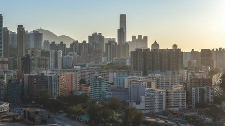 Layered residential towers rise across golden haze filled evening landscape Feb 15 2026のeditorial素材