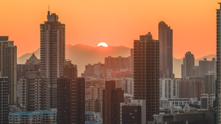 Silhouetted high rise towers rise against golden evening mountainscape Feb 15 2026のeditorial素材