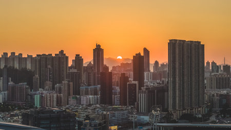 Silhouetted high rise towers rise against golden evening mountainscape Feb 15 2026のeditorial素材