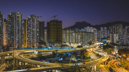 Elevated highway system channels traffic beside colorful housing estates Feb 15 2026のeditorial素材