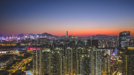 Illuminated towers overlook harbour lights against vibrant evening horizon Feb 15 2026のeditorial素材