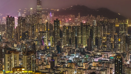 Tightly packed urban towers glow brightly in nighttime cityscape Feb 13 2026のeditorial素材