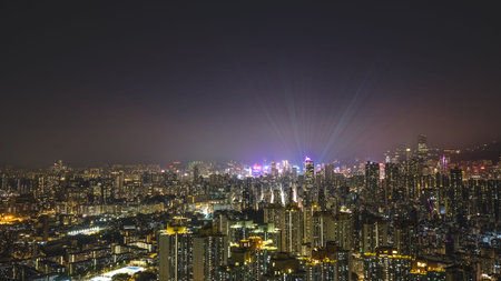Nighttime buildings shimmer beside glowing waterfront and illuminated towers Feb 13 2026のeditorial素材