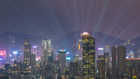 Colorful city lights glow across dense high rise urban landscape Feb 13 2026のeditorial素材