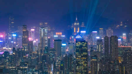 Nighttime buildings shimmer beside glowing waterfront and illuminated towers Feb 13 2026のeditorial素材