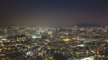 Illuminated residential clusters form vast layered nighttime urban panorama Feb 13 2026のeditorial素材