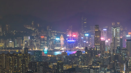 Nighttime buildings shimmer beside glowing waterfront and illuminated towers Feb 13 2026のeditorial素材