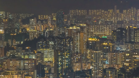 Illuminated residential clusters form vast layered nighttime urban panorama Feb 13 2026のeditorial素材