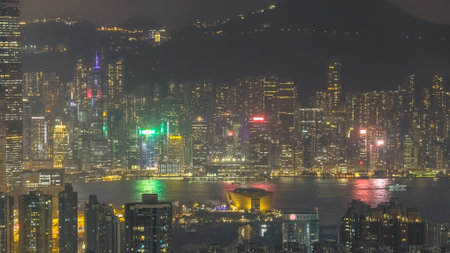 Illuminated high rise clusters create expansive nighttime city landscape Feb 13 2026