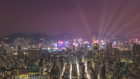 Colorful city lights glow across dense high rise urban landscape Feb 13 2026のeditorial素材