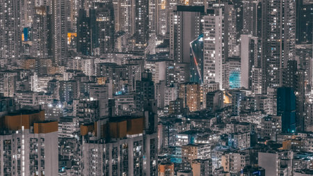 Tightly packed urban towers glow brightly in nighttime cityscape Feb 13 2026のeditorial素材