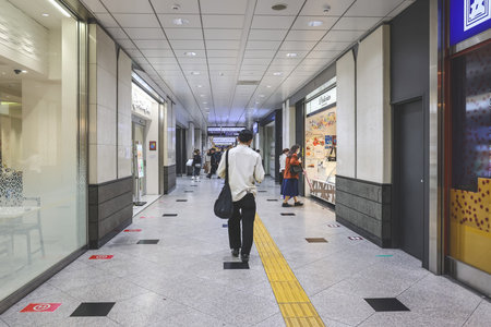 Modern passageway featuring retail stores and commuter flow Nov 25 2025