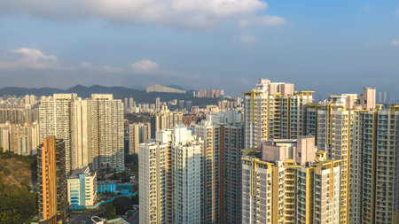High rise district featuring port machinery, housing towers, and distant hills Feb 21 2026