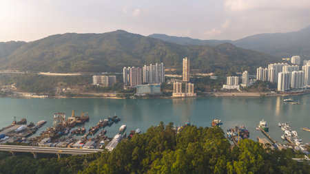 Calm coastal bay featuring vessels, mountains, and terraced residences Feb 21 2026のeditorial素材