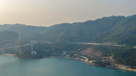 Quiet shoreline area featuring villages, highways, beaches, forested hills Feb 21 2026