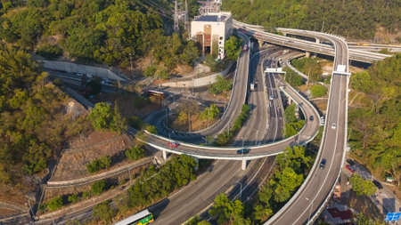 Curving elevated ramps connect major highways through forested hillside Feb 16 2026のeditorial素材