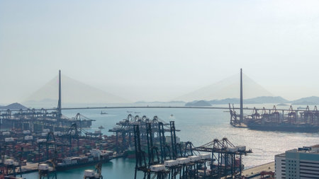 Expansive container port glows beneath warm hazy evening light Feb 16 2026のeditorial素材