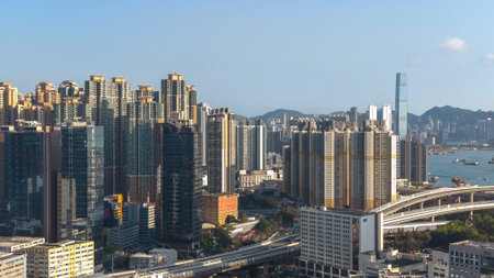 Modern commercial towers rise prominently above dense urban district Feb 16 2026のeditorial素材