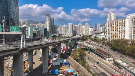 Elevated highways cross busy urban district beneath bright daylight Feb 16 2026