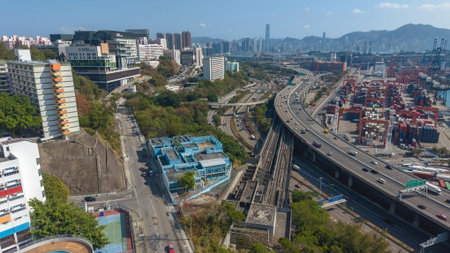 Major elevated highway curves beside cranes and distant mountains Feb 16 2026