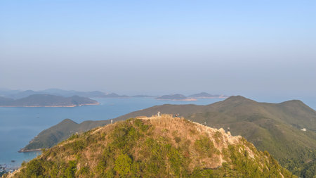 Warm hillside trail leads hikers toward sweeping ocean views Feb 22 2026の写真素材