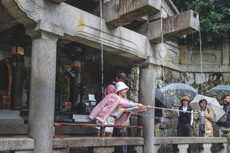 Sacred Waterfall Offering Spiritual Blessings in Historic Kyoto Temple Nov 25 2025