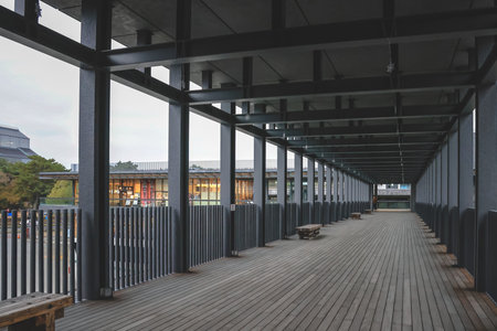 Covered wooden deck walkway outside bus terminal shop Nov 27 2025のeditorial素材