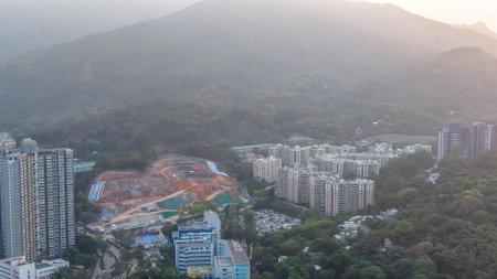 Urban development sits beside forested mountains and housing estates March 7 2026