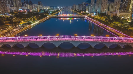 Colorful illuminated bridges glow beside high rise buildings and mountains Feb 1 2026