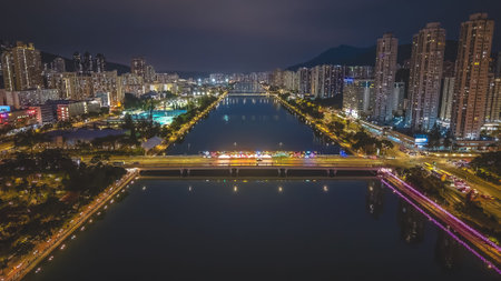 Festive riverfront decorations illuminate bridge and skyline reflections Feb 1 2026のeditorial素材