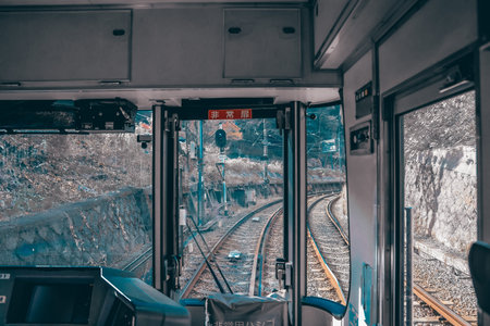 train cab shows tracks curving ahead through calm countryside Nov 27 2025のeditorial素材