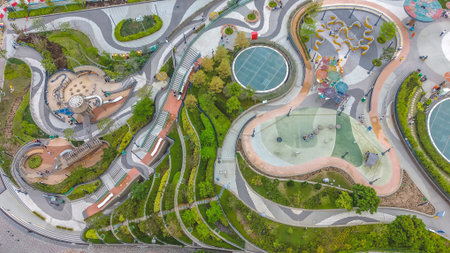 March 27 2026 Flowing garden paths weave around playgrounds and green terraces.のeditorial素材