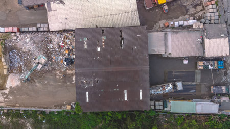 March 27 2026 Corrugated warehouses overlook construction materials arranged in open yards