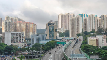 March 27 2026 Traffic flows along highway beside rows of tall residences, HK