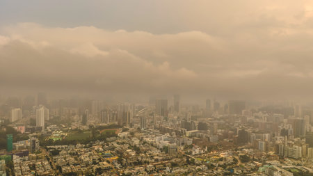 March 27 2026 Residential towers stand below mist-covered mountains in Kowloon.