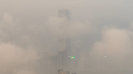 March 27 2026 Tall tower rises through dense fog over cityscape