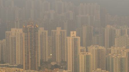 March 27 2026 Residential high rises fade into dense golden evening haze.