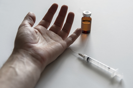 Human arm with medicine vial with syringeの写真素材