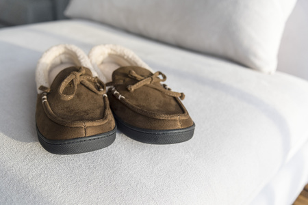 Cozy warm slippers on day bedの写真素材