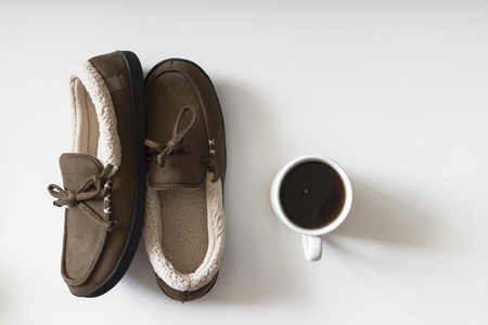 Overhead view of cozy slippers with coffee.の写真素材