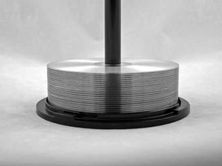 cds and dvds stacked on a spindleの写真素材