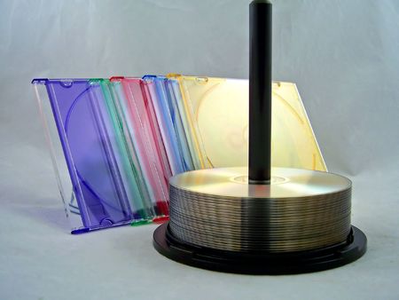 cds on spindle with colorful cd casesの写真素材