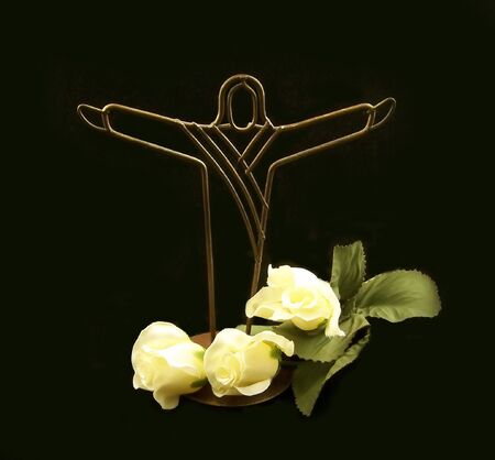Jesus Christ decoration with three yellow rosesの写真素材