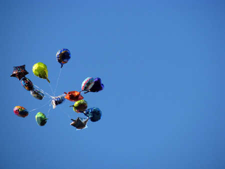 bunch of balloons against clear blue skyの写真素材