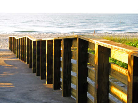 wooden boardwalk leading to the ocean beachの写真素材