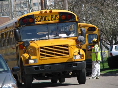 view of man directing school bus traffic