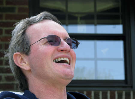 photo of happy middle age man laughing