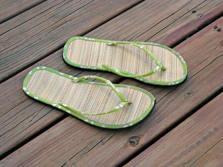 pair of summer sandals on wood deckの写真素材