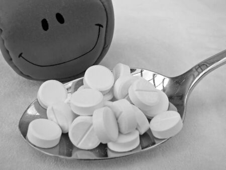 spoon with pills and happy smiling face